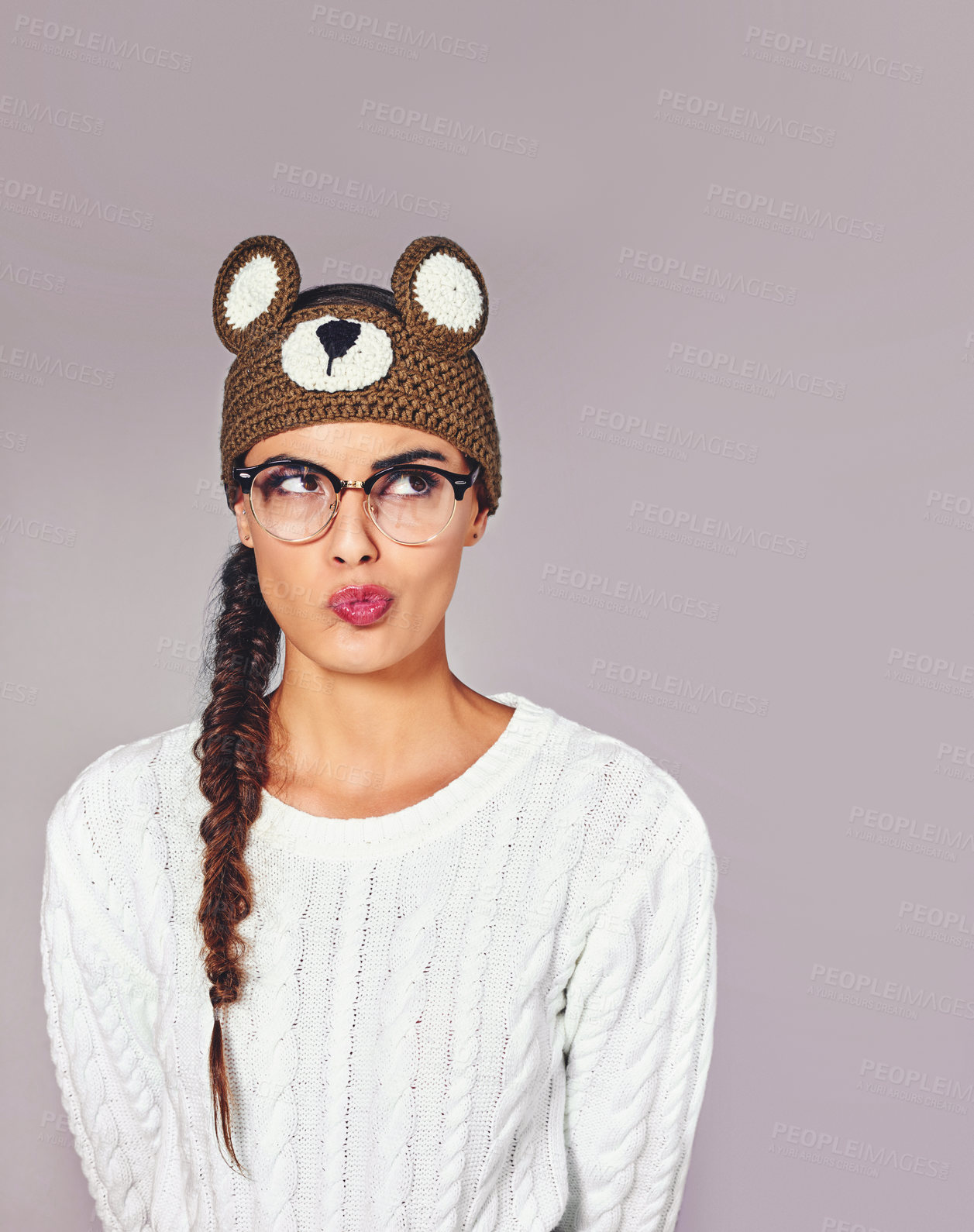 Buy stock photo Studio, woman and pout with beanie for fashion, winter outfit and teddy bear style with expression. Female person, quirky and trendy with thinking for crochet headband, wool hat and white background