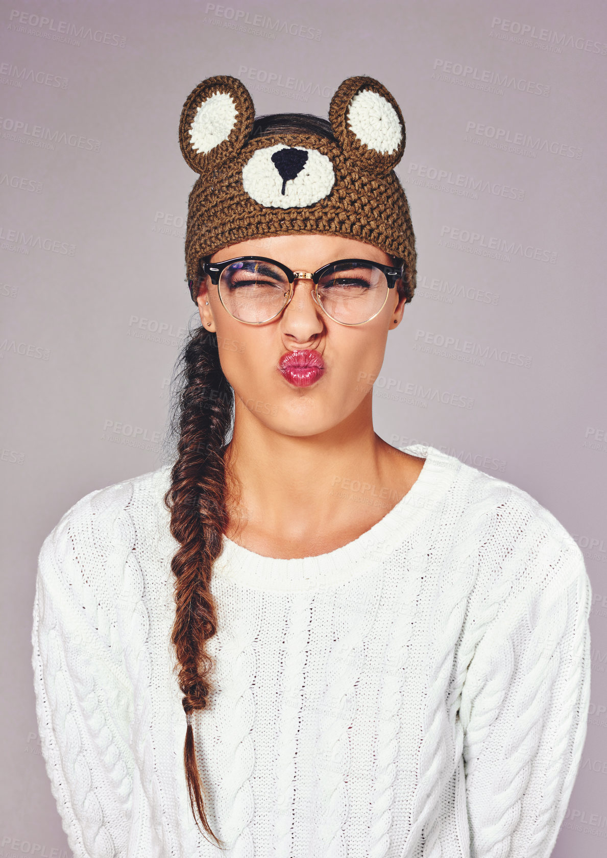 Buy stock photo Studio, woman and pout in portrait for fashion, winter outfit and teddy bear beanie for style. Female person, goofy and model with emoji expression for crochet headband, wool and isolated background