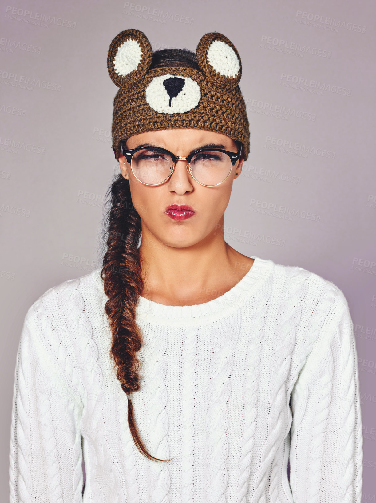 Buy stock photo Studio shot of a young woman wearing a brown teddy bear beanie