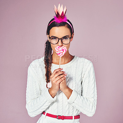 Buy stock photo Candy, colorful and portrait of woman in studio for sweet snack, costume or stylish clothes. Female person, confident and crown with lollipop by pink background for halloween treat, fashion or outfit