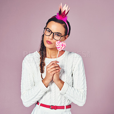 Buy stock photo Candy, serious and portrait of woman in studio for sweet treat, costume and stylish fashion. Female person, outfit and crown with lollipop by pink background for halloween snack, colorful and clothes