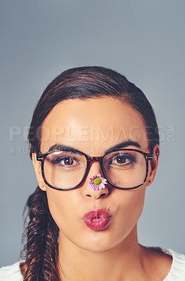 Buy stock photo Woman portrait, glasses and flower for eye care in studio, pout and designer frames for optometry. Person, optical insurance and proud for eco friendly healthcare, spectacles and gray background