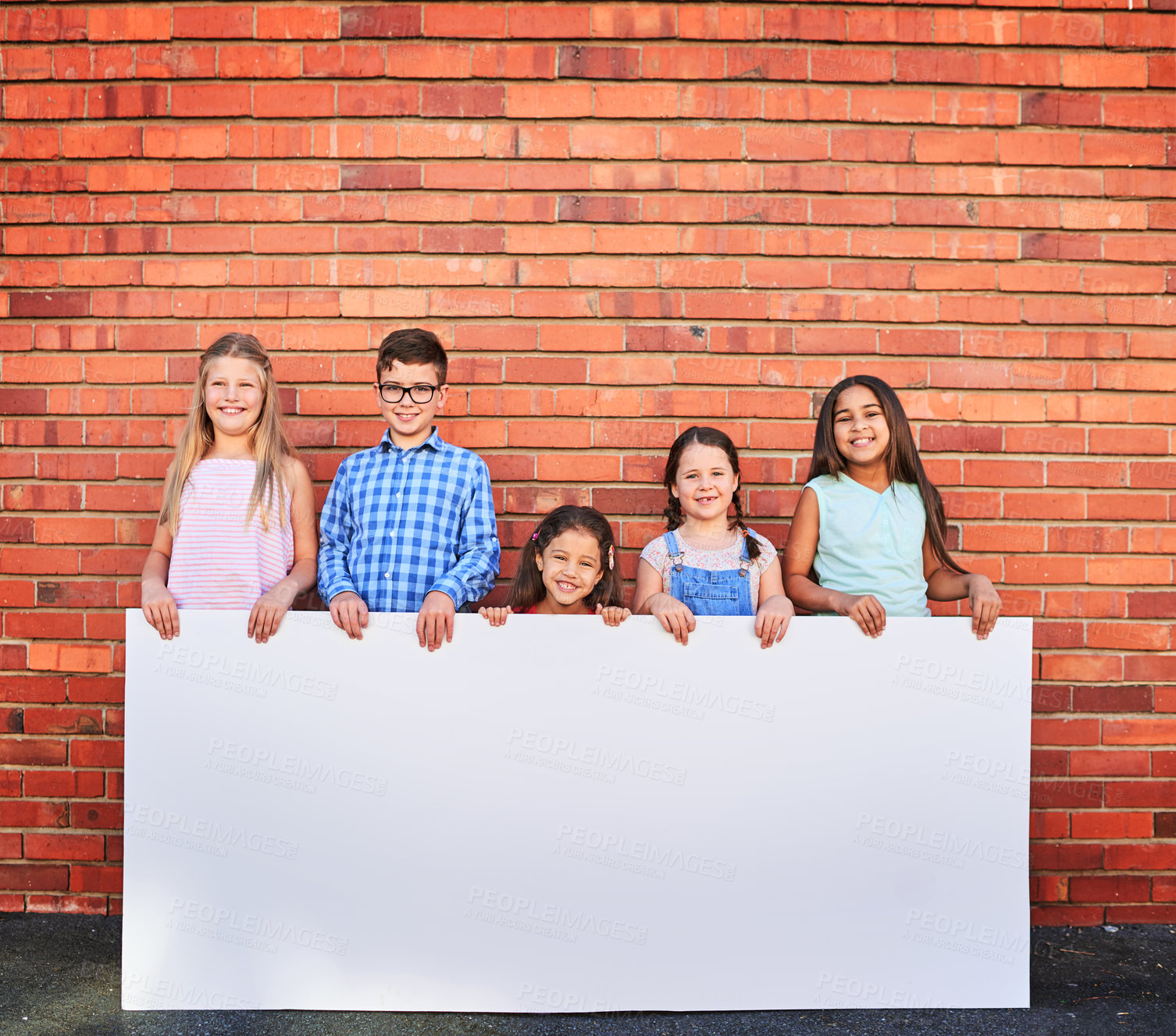 Buy stock photo Kids, wall and outdoor with sign board in smile or fun and colors for promotion and advertisement. People, banner and happy with poster for child development in portrait as friends with mockup