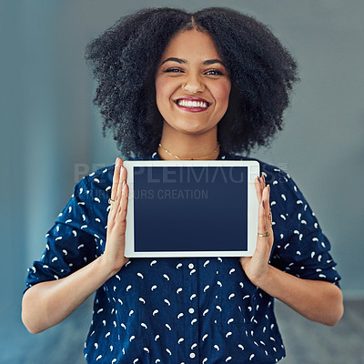 Buy stock photo Studio shot of a young woman holding up a digital tablet with a blank screen against a gray background