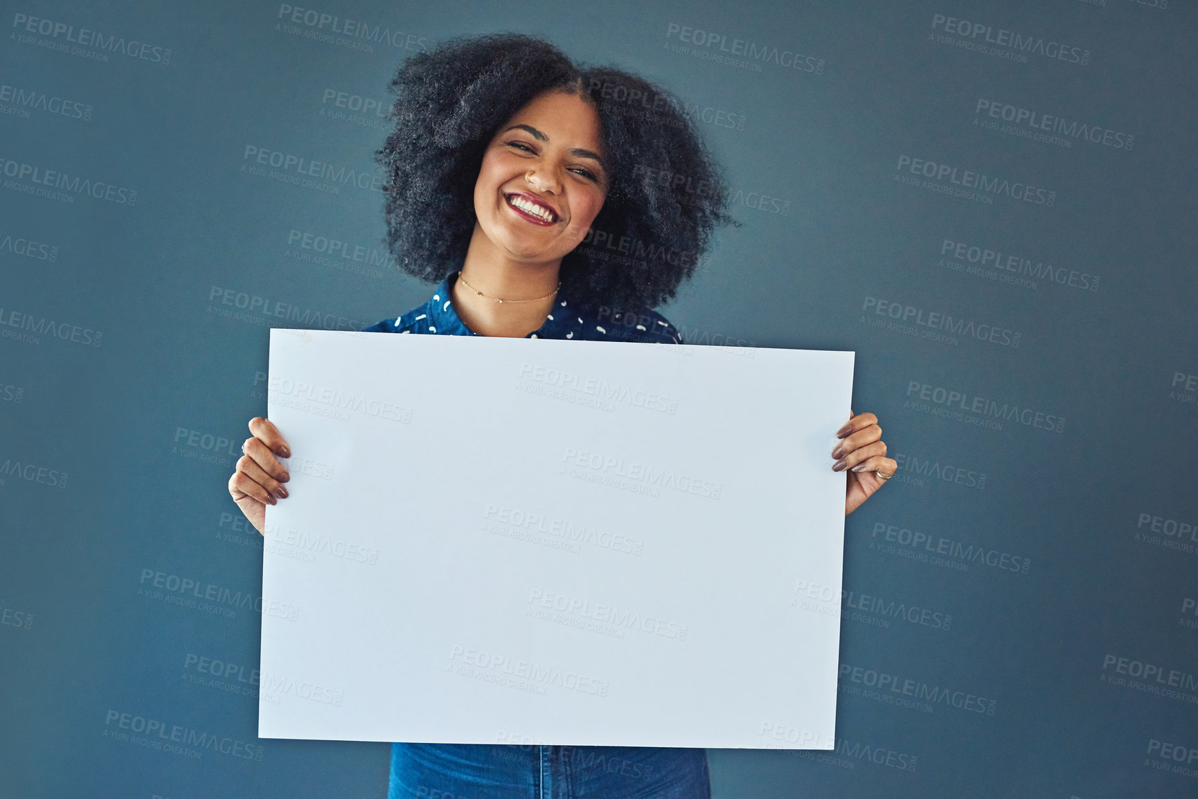Buy stock photo Happy, mockup and portrait of a woman with a sign isolated on a blue background in studio. Smile, showing and young corporate copywriter with a blank board for branding, design and information space