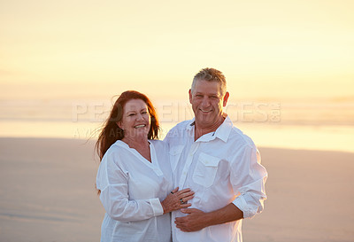 Buy stock photo Shot of mature people enjoying the sunset on the beach