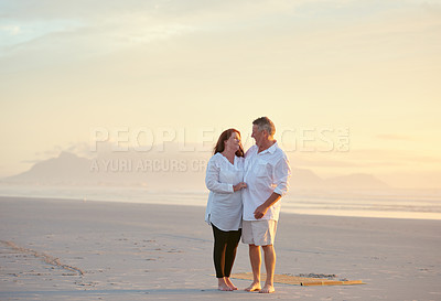 Buy stock photo Shot of mature people enjoying the sunset on the beach