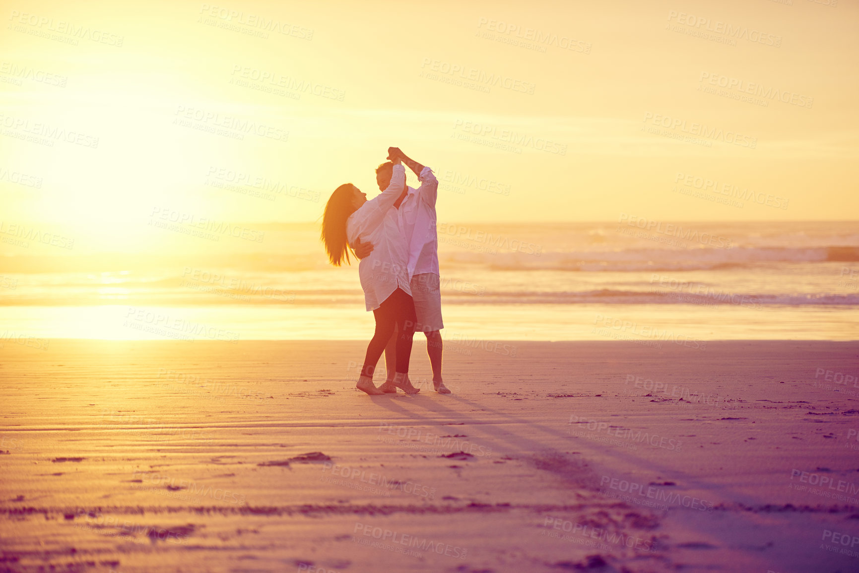 Buy stock photo Full length shot of an affectionate mature couple dancing on the beach at sunset