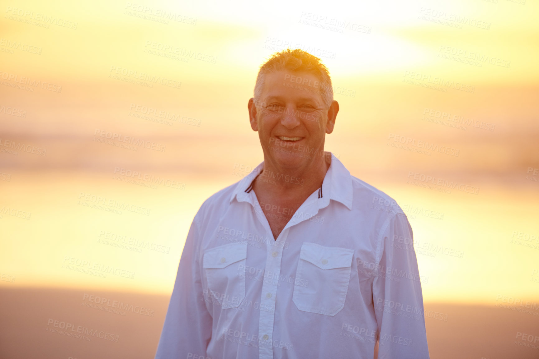 Buy stock photo Portrait, happy and mature man on beach for sunset, vacation and travel or outdoor trip. Smile, male person and holiday for morning, relax and weekend break for tourism with sunshine in Miami