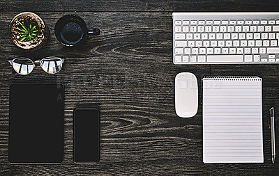 Buy stock photo High angle shot of a variety of wireless devices on a work desk