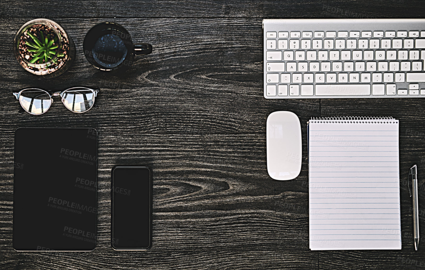 Buy stock photo High angle shot of a variety of wireless devices on a work desk