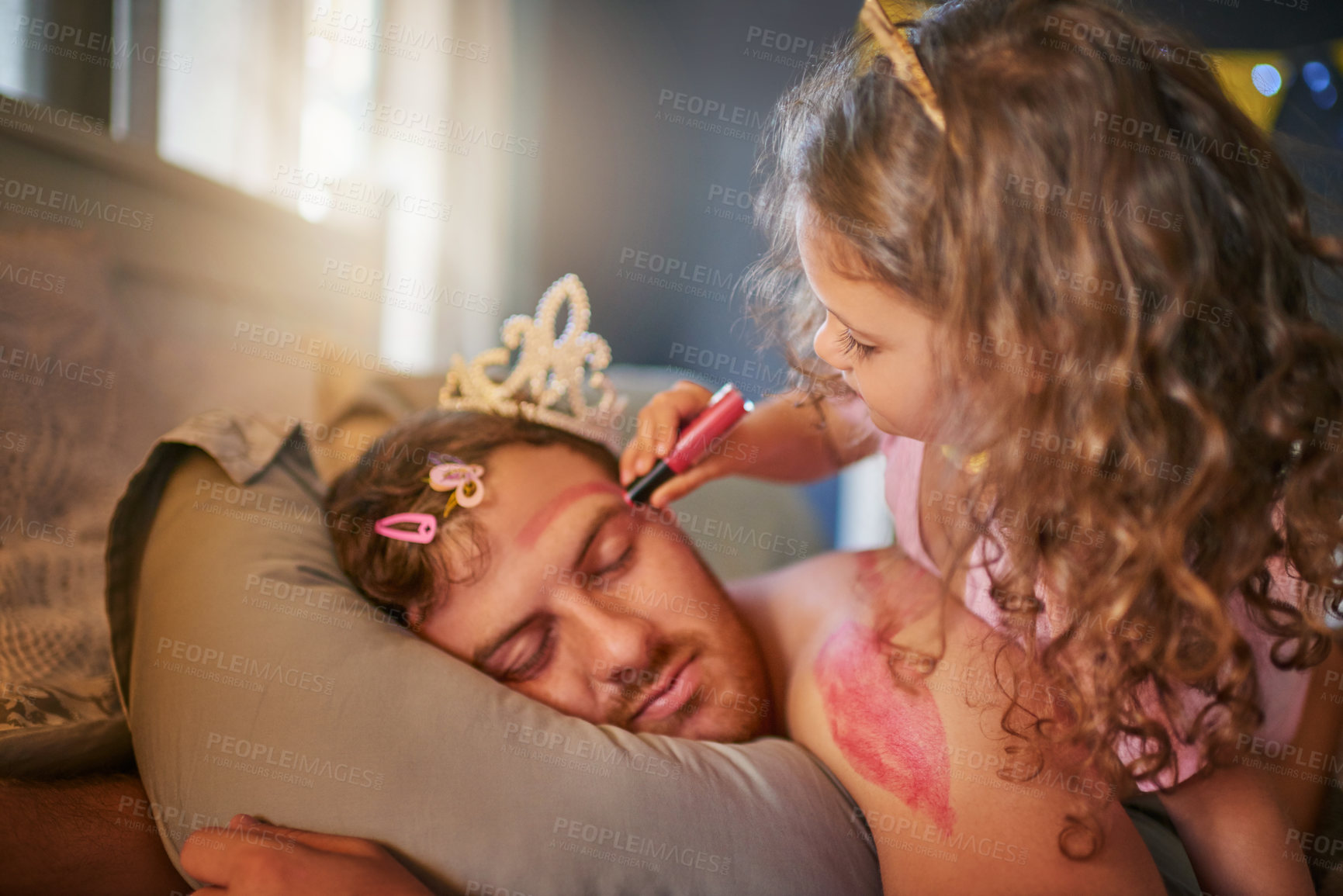 Buy stock photo Shot of an adorable little girl drawing with lipstick on her father's face while he sleeps