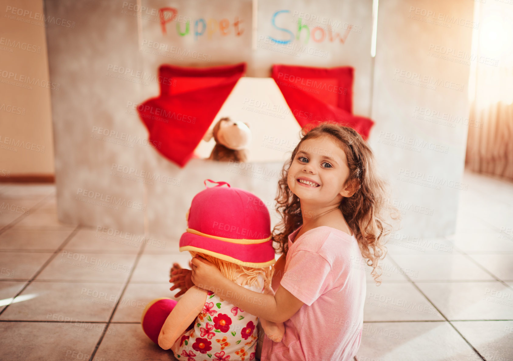 Buy stock photo Puppet show, happy and portrait of girl on floor for theatre, creative play and fantasy cinema. Storytelling, games and performance with child and cardboard stage at home for youth entertainment