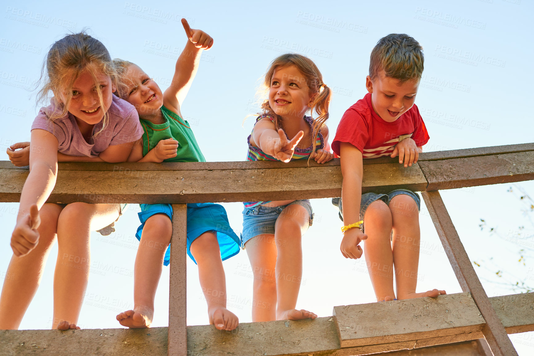 Buy stock photo Portrait of a group of little children showing thumbs up while playing together outdoors