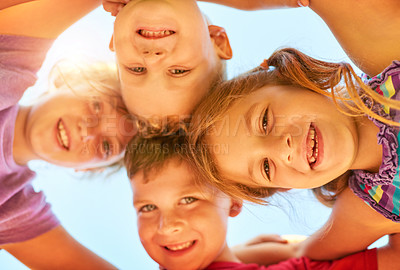 Buy stock photo Portrait of a group of little children standing together in a huddle outdoors