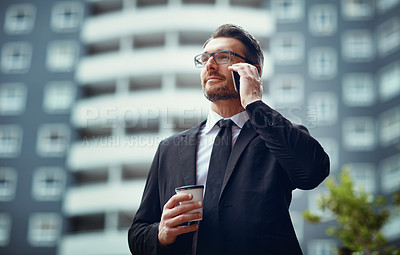 Buy stock photo Shot of a mature businessman talking on cellphone while out in the city