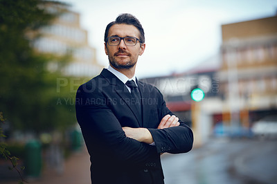 Buy stock photo Shot of a mature businessman looking thoughtful while standing in the city
