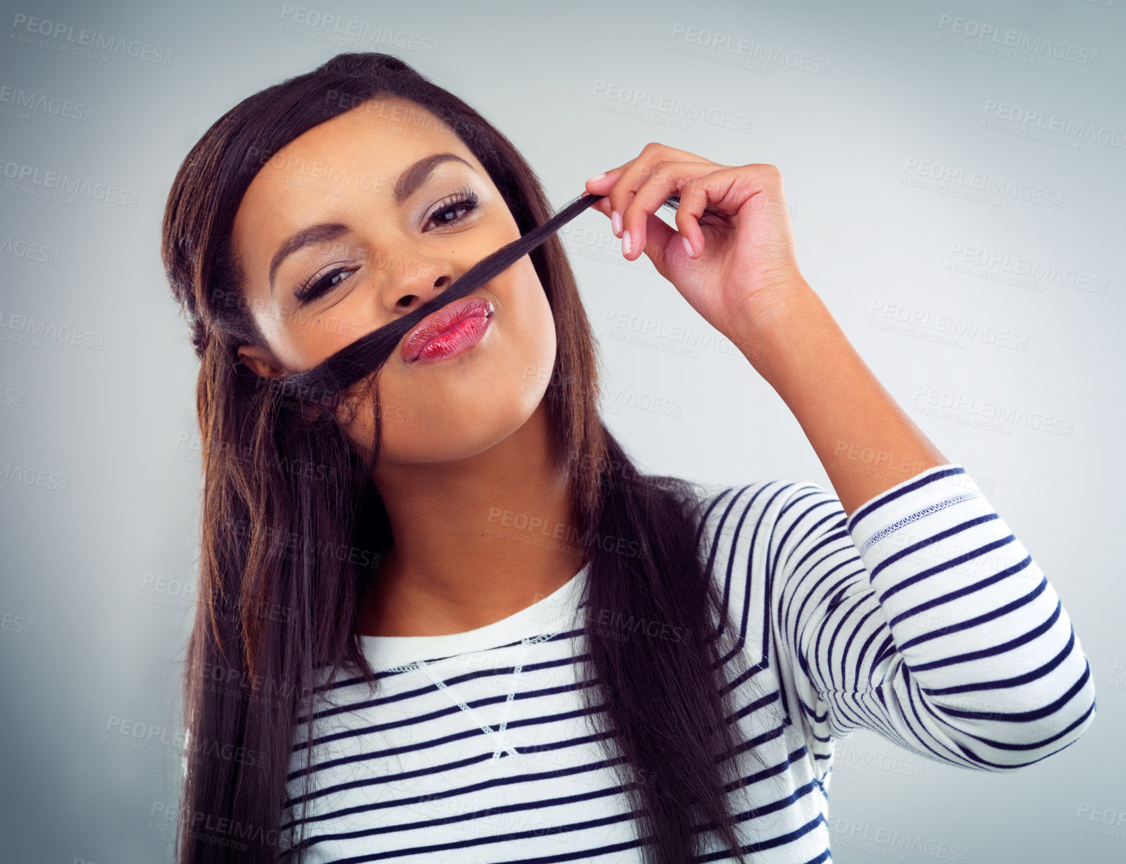 Buy stock photo Shot of a young woman posing against a grey background