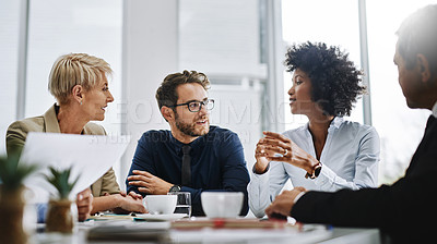 Buy stock photo Shot of a group of businesspeople sitting together in a meeting