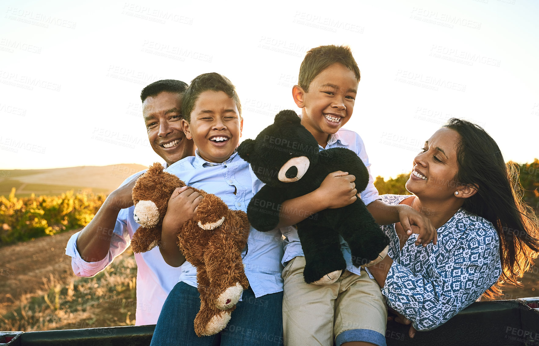 Buy stock photo Portrait of a happy family bonding together outdoors