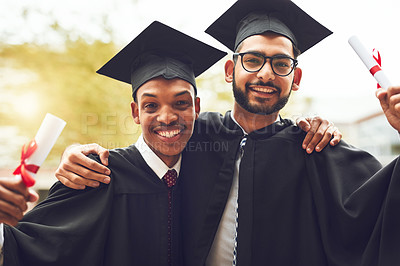 Buy stock photo Cropped shot of two fellow students standing outside on graduation day