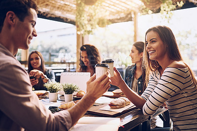 Buy stock photo Shot of friends toasting with cups of coffee while out for lunch