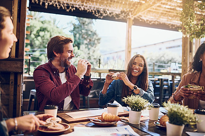 Buy stock photo Cropped shot of friends enjoying themselves while out for lunch