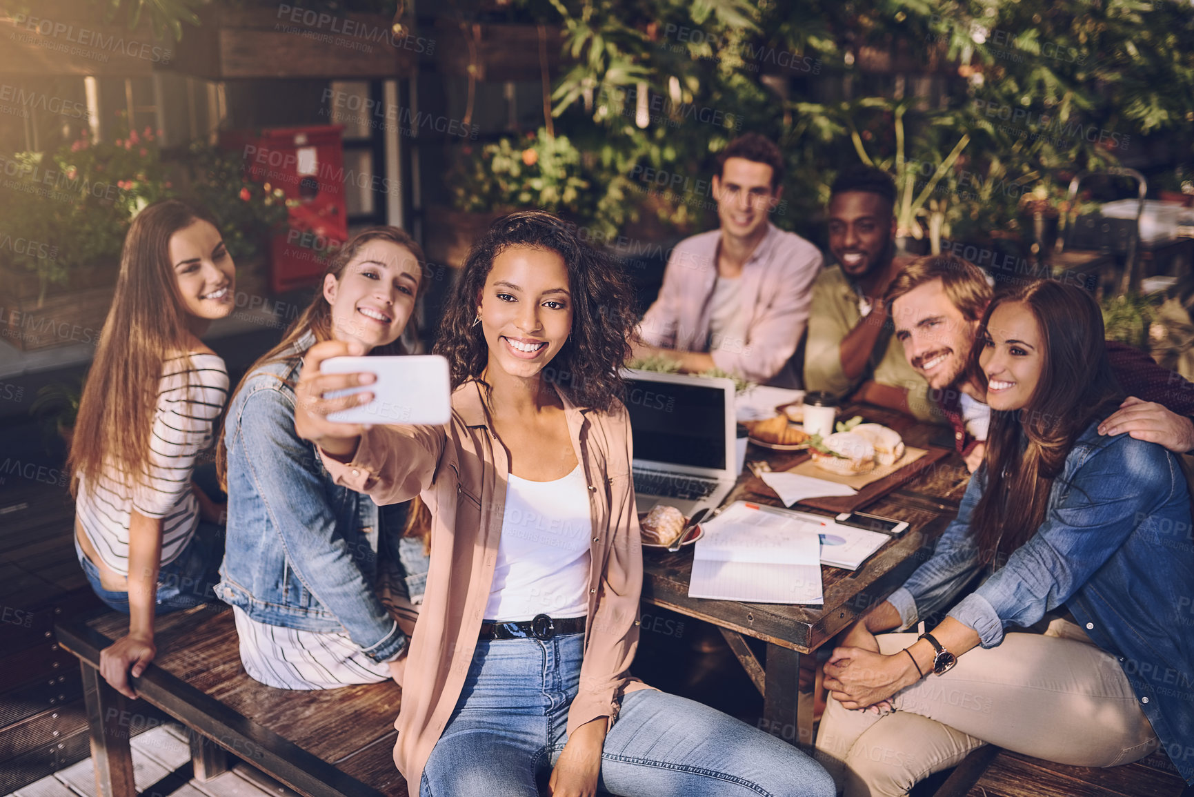 Buy stock photo Shot of a woman taking a selfie with her colleagues while out for lunch
