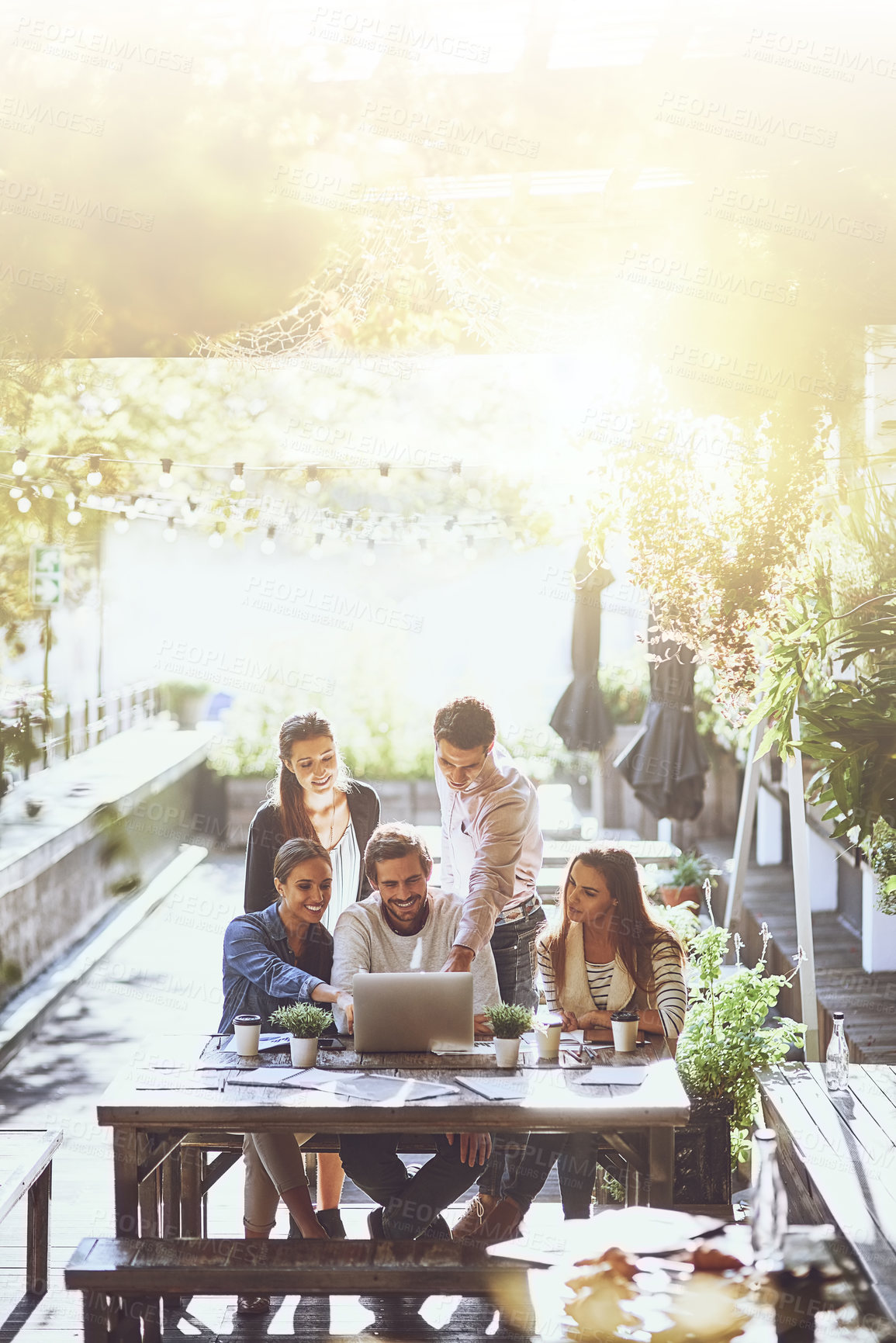 Buy stock photo Sunshine, planning and business people in meeting, laptop and cooperation with ideas, creative agency or feedback. Group, diversity and employees with pc, lens flare or collaboration with internet