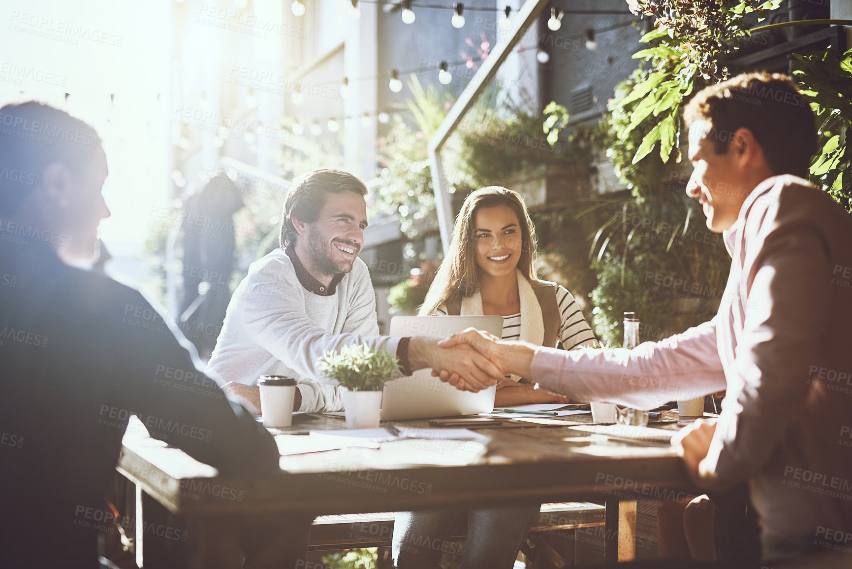 Buy stock photo Businessman, team and handshake in meeting at cafe for welcome, b2b networking or collaboration outdoor. Group, employees and shaking hands for onboarding, partnership deal and happy for agreement