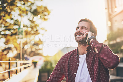 Buy stock photo Cropped shot of a handsome man talking on his cellphone
