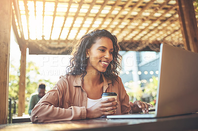 Buy stock photo Cropped shot of a young woman using a laptop in a coffee shop