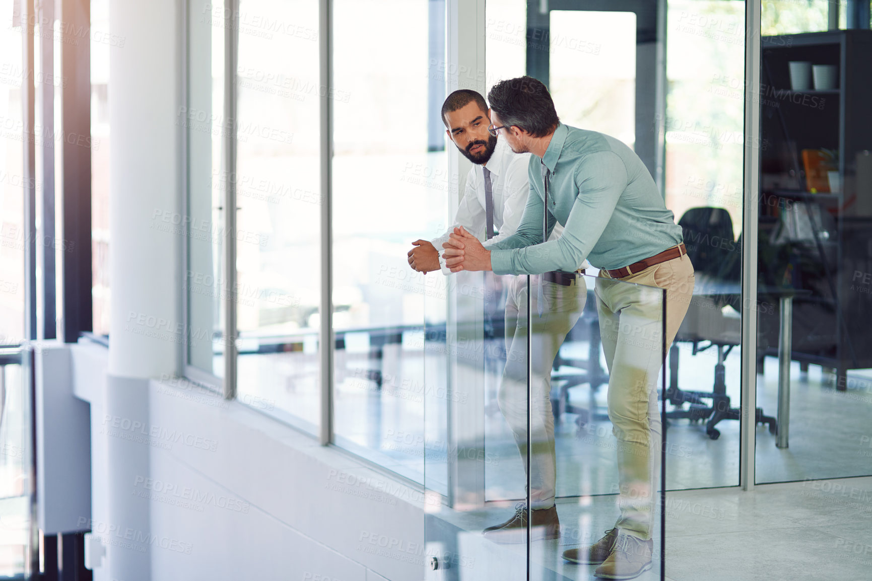 Buy stock photo Shot of colleagues having a discussion in a modern office