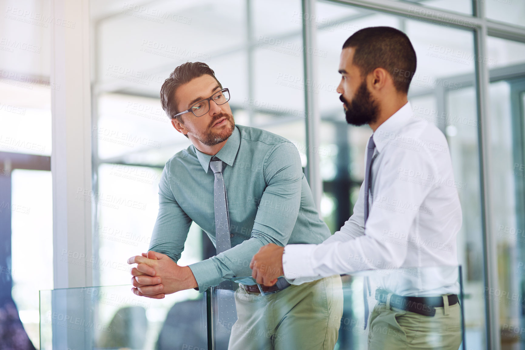 Buy stock photo Shot of colleagues having a discussion in a modern office