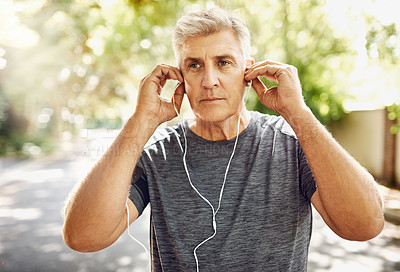 Buy stock photo Mature man, music and headphones on street for running, fitness and exercise for wellness. Male runner, listening and audio for motivation with training, morning start to workout in New York City