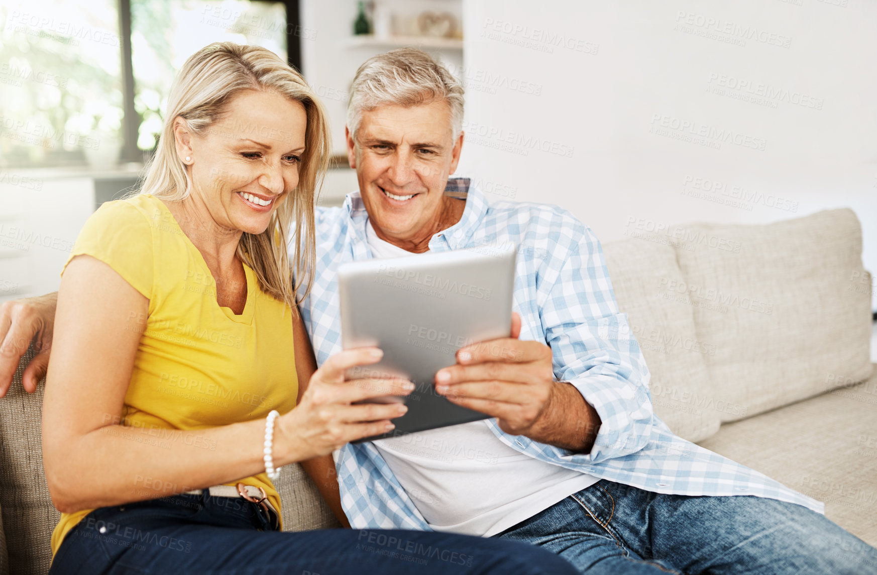 Buy stock photo Couple, read and tablet on sofa for social media, scroll and news report online on couch. Technology, internet and app on digital website in home, man and woman people in lounge with touchscreen