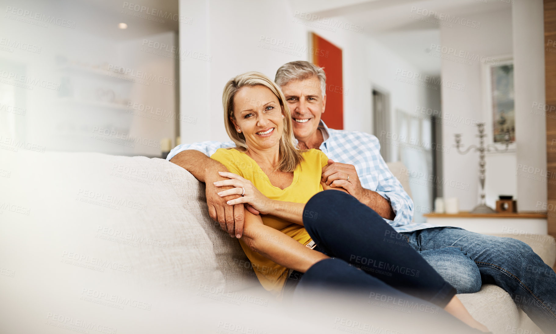 Buy stock photo Cropped shot of a loving mature couple relaxing at home