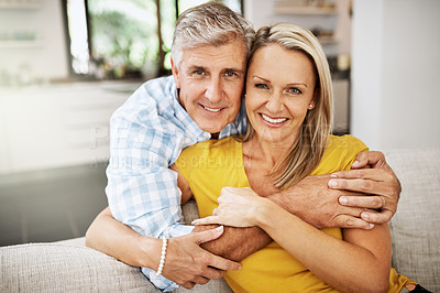 Buy stock photo Happy, in love and affectionate senior couple hugging on the sofa in the living at room, enjoying time together and their retirement. Portrait of a happy man and woman bonding and smiling at home