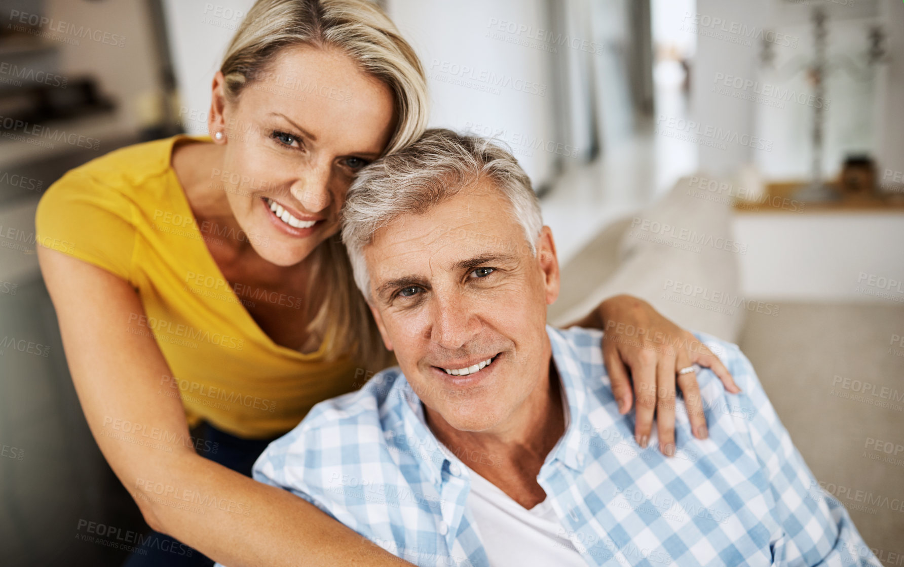 Buy stock photo Cropped shot of a loving mature couple relaxing at home