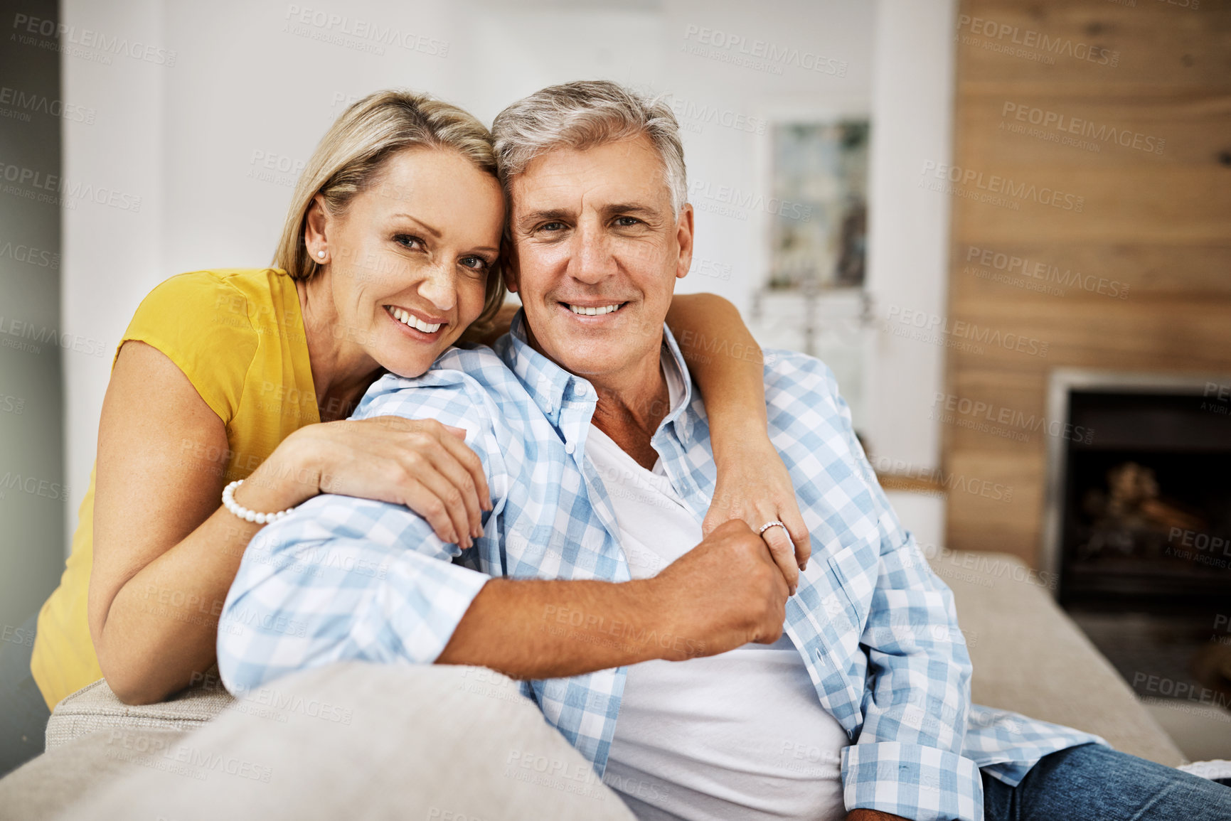 Buy stock photo Cropped shot of a loving mature couple relaxing at home