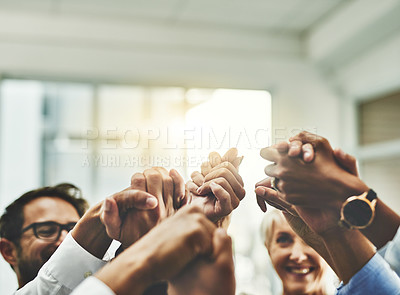 Buy stock photo Shot of a group of unrecogniasble businesspeople holding hands in unity in an office
