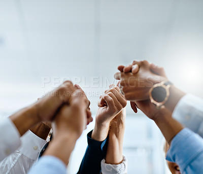 Buy stock photo Shot of a group of unrecogniasble businesspeople holding hands in unity in an office