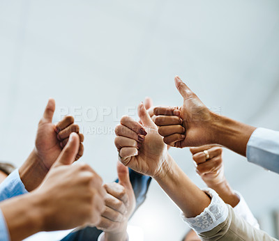Buy stock photo Shot of a group of unrecognisable businesspeople showing thumbs up in an office