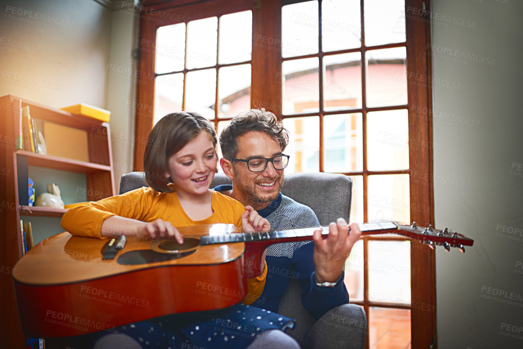 Buy stock photo Father, guitar and girl in home for teaching, bonding and development with music, relax and playing. Dad, instrument and daughter in apartment for relationship, learning and hobby with fun lesson