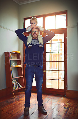 Buy stock photo Portrait of a father carrying his little son on his shoulders at home
