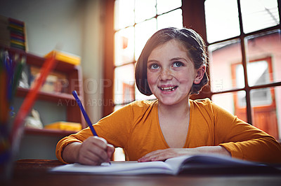 Buy stock photo Shot of a little girl doing homework inside