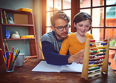 Buy stock photo Shot of a father helping his little daughter with her homework