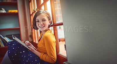 Buy stock photo Portrait of a little girl using a digital tablet at home