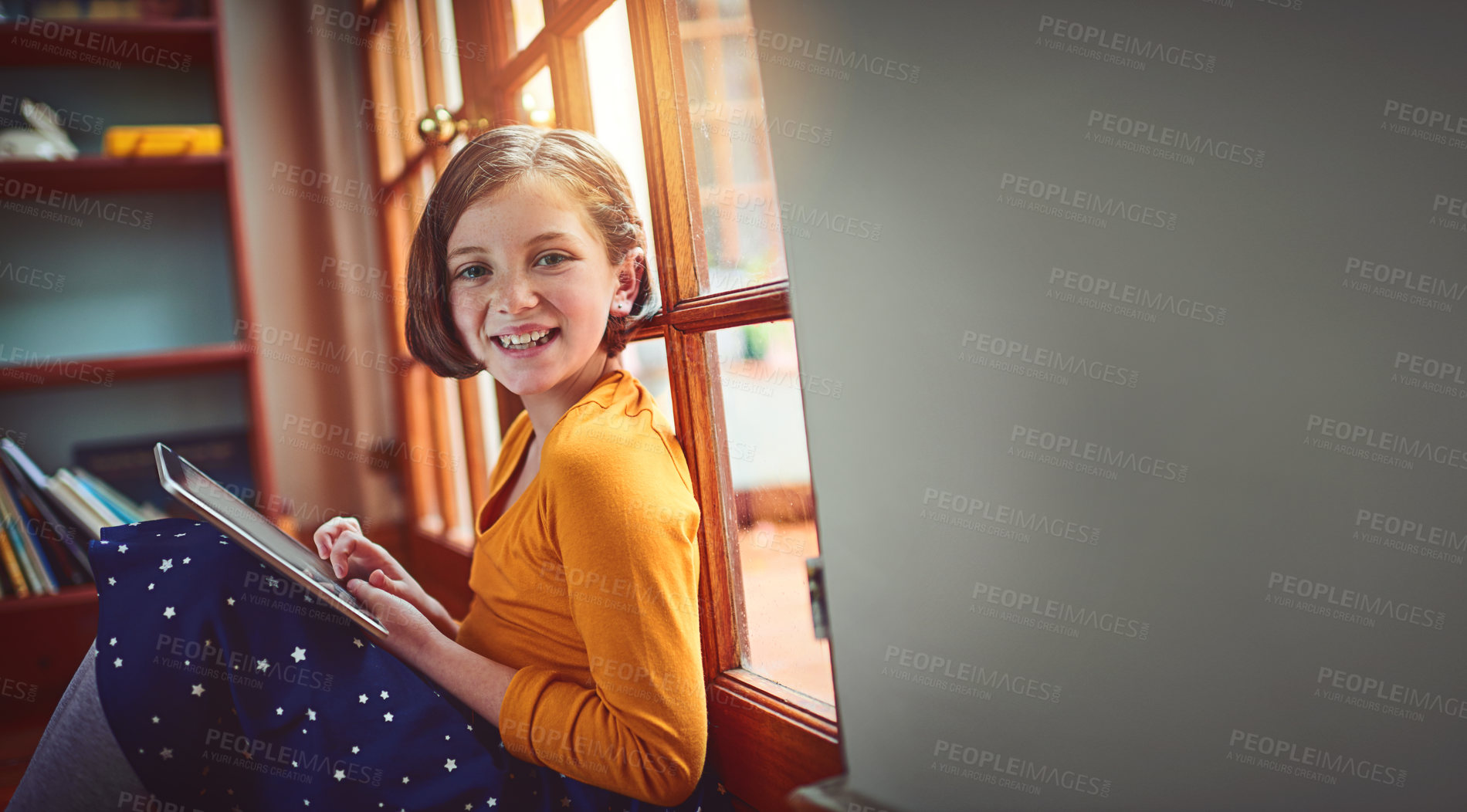 Buy stock photo Portrait of a little girl using a digital tablet at home