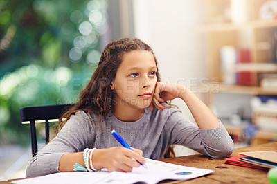 Buy stock photo Cropped shot of a young girl doing homework inside